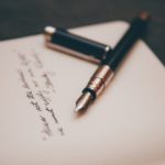 An open calligraphy pen on a book
